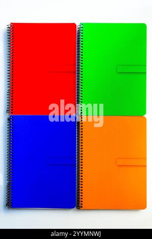Red, blue, green and orange spiral notes on white background Stock Photo