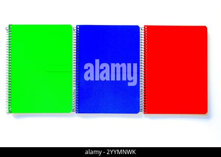 Red, blue and green and spiral notes on white background Stock Photo