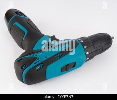 Cordless drill-driver insulated on a light background, Ergonomic design and comfortable to work in all conditions. Stock Photo
