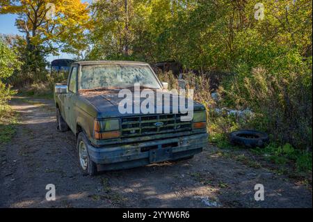 old Ford Ranger pick-up truck abandoned on pathway in junk yard. Stock Photo