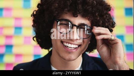 Man, happy and glasses in office for planning, opportunity and agenda on creative moodboard. Designer, smile and vision at sticky notes with timeline Stock Photo