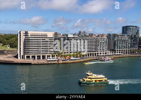 Sydney ferry the MV Scarborough leaves Circular Quay travelling past the toaster apartment buildings at east circular quay, Sydney,NSW,Australia,2024 Stock Photo