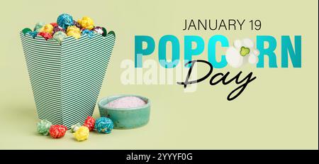 Bucket with sweet popcorn and bowl of sugar on green background. Banner for National Popcorn Day Stock Photo