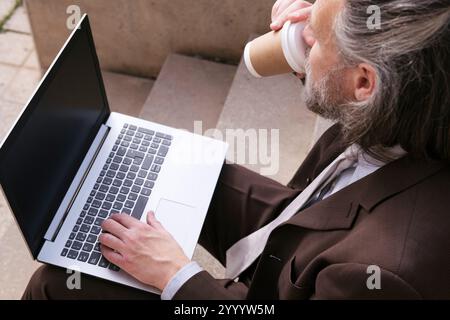 entrepreneur in formal suit sitting on stairway Stock Photo