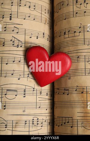 Heart figure on musical note sheets, closeup Stock Photo