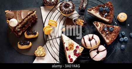 Table with various cookies, donuts, cakes, cheesecakes Stock Photo