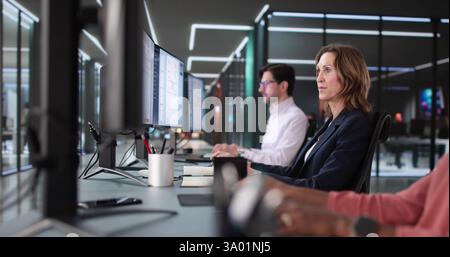 Working Together on Electronic Invoices with Diverse Accounting Team Stock Photo