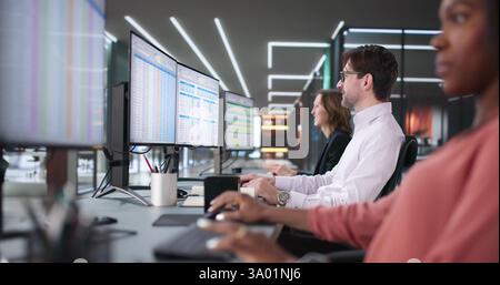 Team of diverse professionals using software to create billing reports Stock Photo