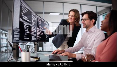 Diverse coding team collaborating on software development at the office. Stock Photo