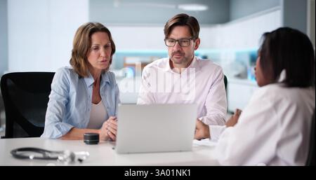 African couple at the hospital, happy and pregnant, consulting doctor. Possible professions: doctor, nurse, technician, obstetrician. Stock Photo