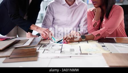 Custom House Remodeling Team Discussing Design Ideas at Kitchen Desk Stock Photo