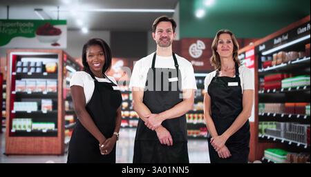Smiling African-American executive manager leads diverse supermarket retail store team Stock Photo