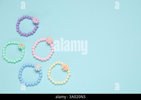 Different hair ties on light blue background, flat lay. Space for text Stock Photo