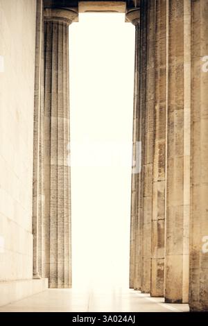 Majestic classical columns in a historic building. Symmetric architectural perspective with soft light. ideal for cultural and architectural themes. Stock Photo
