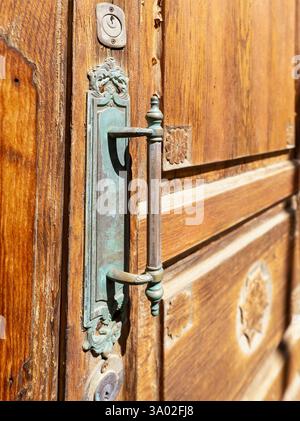 Close-up of an old oxidized door handle on a historic front door. Stock Photo