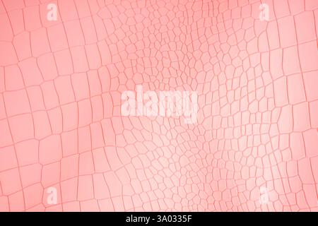 Pink color crocodile skin artificial leather with waves and folds on PVC base. Stock Photo