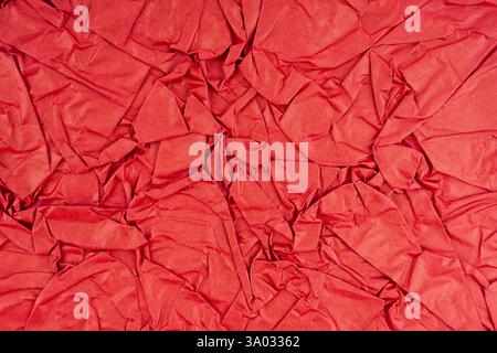 Red crumpled paper textured as background. Stock Photo