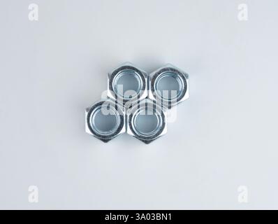 Metal nuts arranged in a geometric pattern Stock Photo