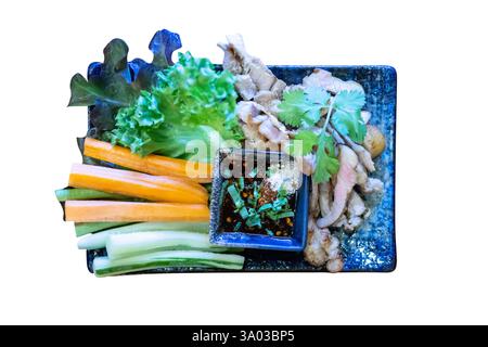 Die cut of Grilled pork with dipping sauce with mix vegetable as carrot, cucumber, Lettuce on white isolated. Stock Photo