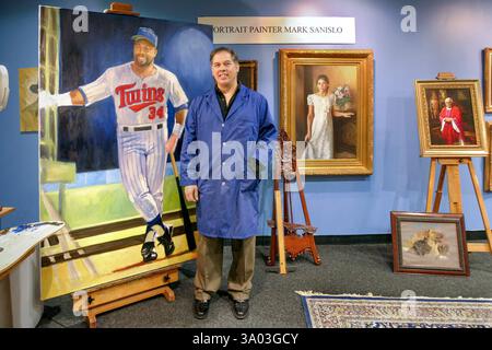 Artist and portrait painter Mark Sanislo standing next to his painting in progress of Kirby Puckett at his downtown Minneapolis, Minnesota art studio. Stock Photo