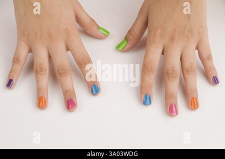 Different colours of nail polish on nails Pune Maharashtra India Asia May 2011 Stock Photo
