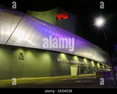 The Imperial War Museum North at night in Salford Quays, Greater Manchester, UK Stock Photo