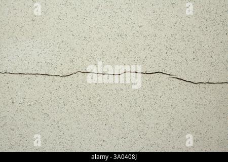 Cracked wall surface shows texture and imperfections in a residential building Stock Photo