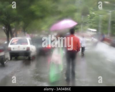 Couple is walking on road through car wind-shield Stock Photo