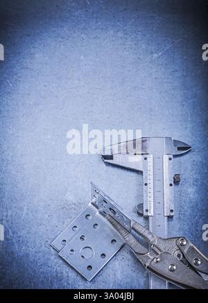 Adjustable pliers wrench slide caliper angle bracket on metallic background Stock Photo