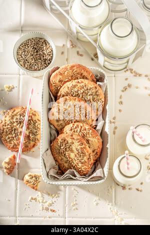 Top down view of sunflower seed cookies as breakfast snack. Shortbread cookies with milk. Stock Photo