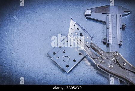 Adjustable pliers wrench vernier caliper angle bracket on metallic background Stock Photo