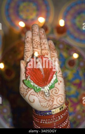 Woman holding diya dip dipak oil lamp on hand, Mehandi Heena pattern, Diwali deepawali festival, India, Asia Stock Photo