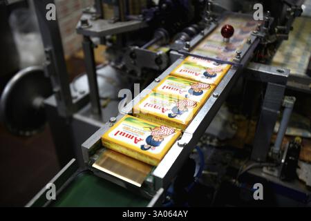 Amul butter packed in wrappers on conveyor belt in Amul factory in ...