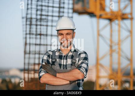 Handsome man is working on the construction site at daytime. Stock Photo