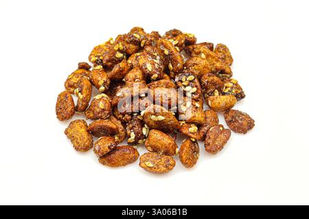 Pile of sweet caramelized peanuts with sesame isolated on white background Stock Photo