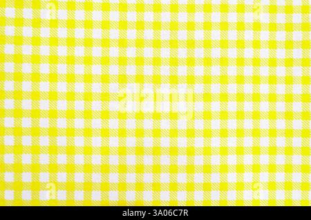 Overhead view of flat woven fabric with yellow hasehed pattern on white, forming squares and overlapping yellow patterns. Stock Photo