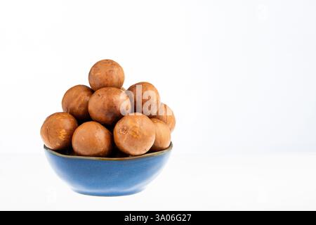 Macadamia integrifolia - Organic macadamia nuts in bowl. Stock Photo