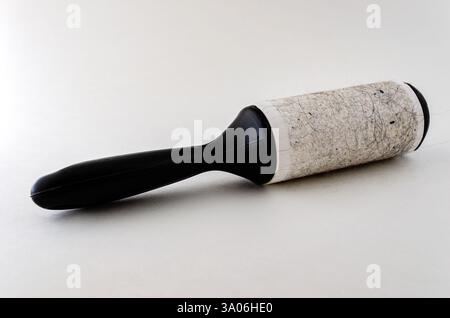 Single sticky roller with pet hair isolated on a white background Stock Photo