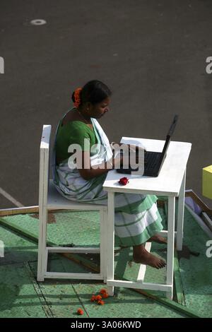 Indian lady in Indian sari working on laptop or notebook NO MR Stock Photo