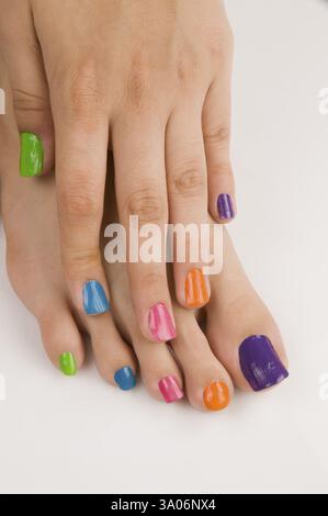 Different colours of nail polish on nails Pune Maharashtra India Asia May 2011 Stock Photo