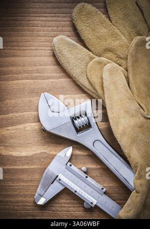 Adjustable wrench leather safety gloves slide caliper construction concept Stock Photo