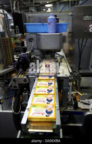 Amul butter packed in wrappers on conveyor belt in Amul factory in ...