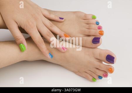 Different colours of nail polish on nails Pune Maharashtra India Asia May 2011 Stock Photo