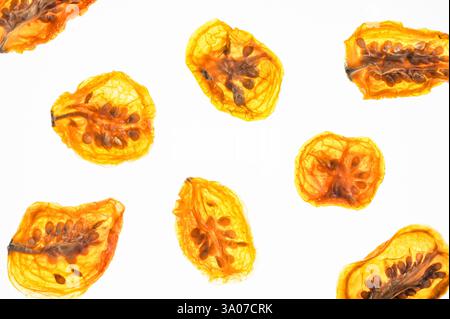 Sliced dried cherry tomatoes on a white background Stock Photo