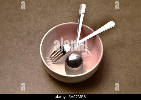 Minimalistic Bowl and Cutlery Set on Neutral Background Stock Photo