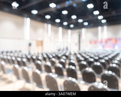 Abstract blurred scene of many empty chairs in seminar conference or meeting room in town hall background, white indoor interior auditorium or hotel r Stock Photo