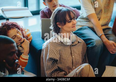 A group of students listening attentively during an education session, reflecting collaborative learning and active engagement in a diverse academic s Stock Photo