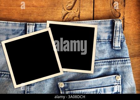 Nostalgic scrapbooking banner with jeans on wooden board and two retro frame photo. Horizontal background with denim trousers of blue color and blank Stock Photo