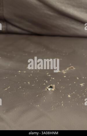 Worn ripped torn brown leather sofa couch textured cover background backdrop. Stock Photo