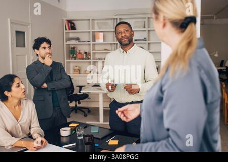 Focused male and female business professionals planning strategies during meeting in creative office Stock Photo